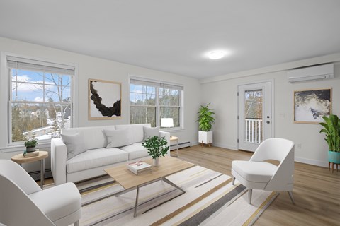 A living room with a white couch, a coffee table, and a large window with a view of the outdoors.