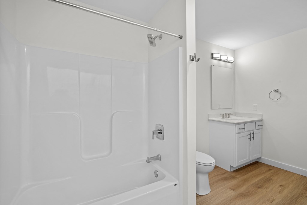 a bathroom with a shower and a sink and a toilet