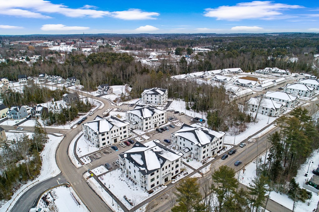 an aerial view of a city with buildings in the snow