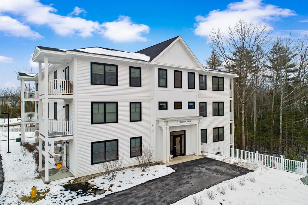 a large white house with snow on the ground