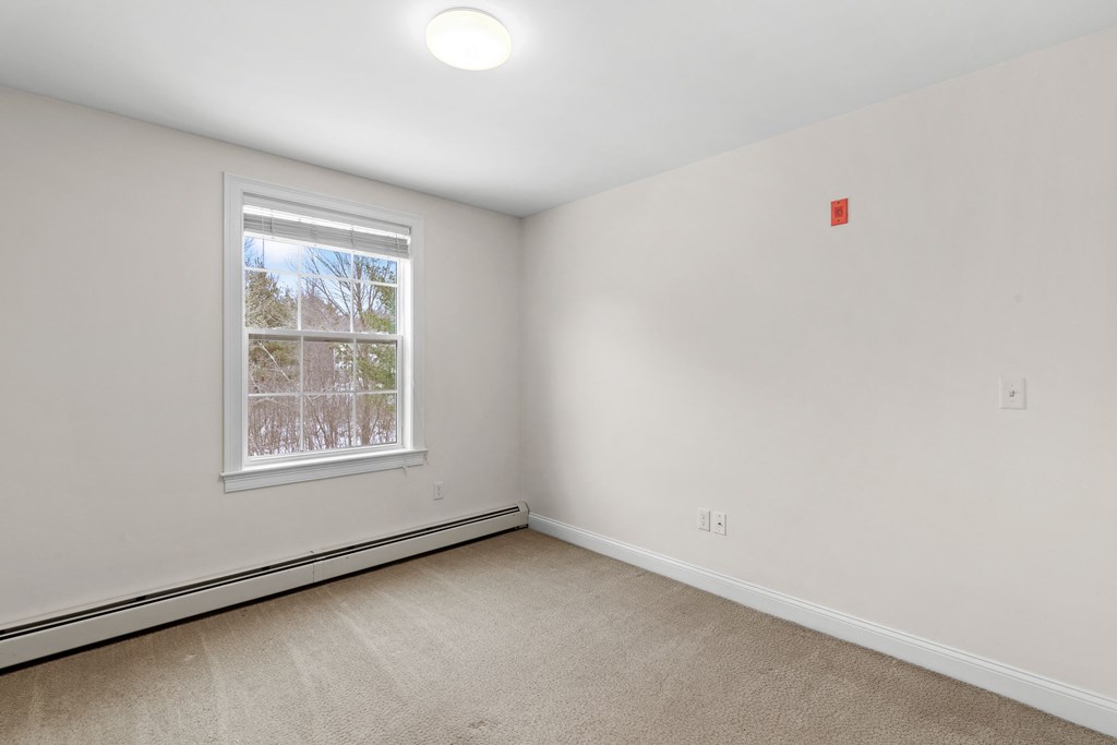 an empty room with white walls and a window