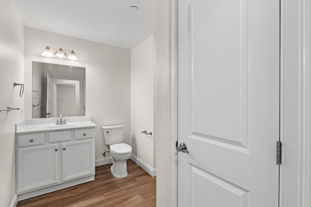 a bathroom with a toilet and a sink and a mirror