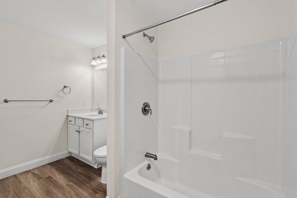 a bathroom with a shower and a sink and a toilet