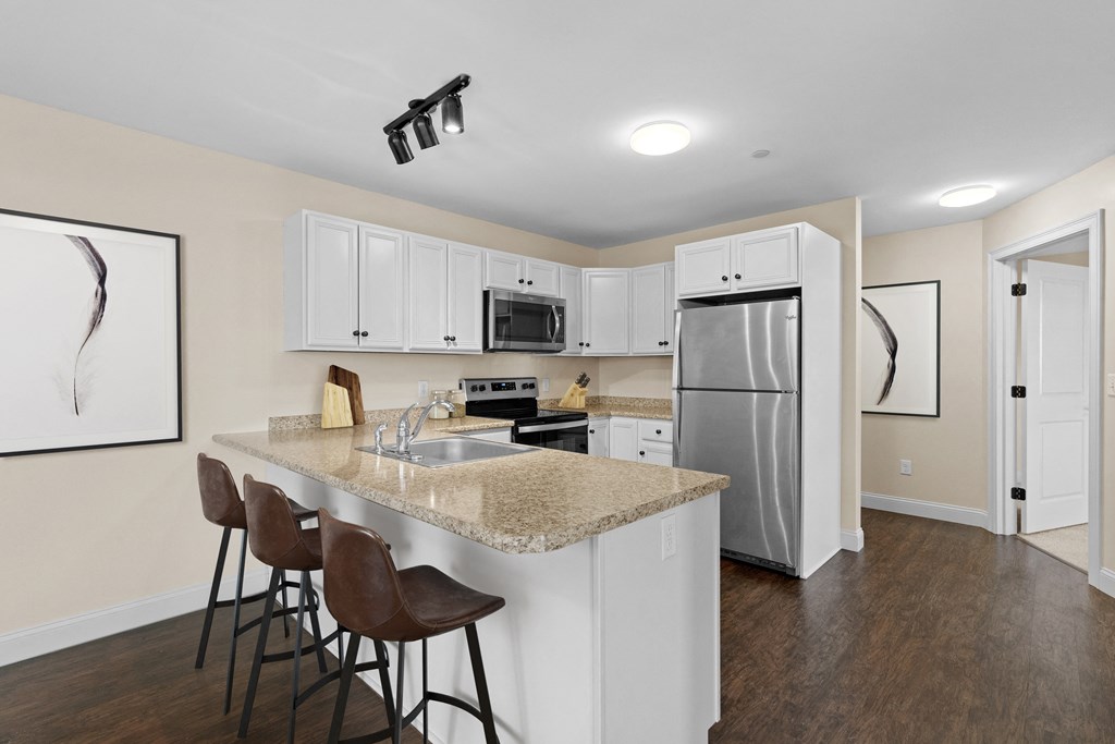 a kitchen with a granite counter top and stainless steel appliances