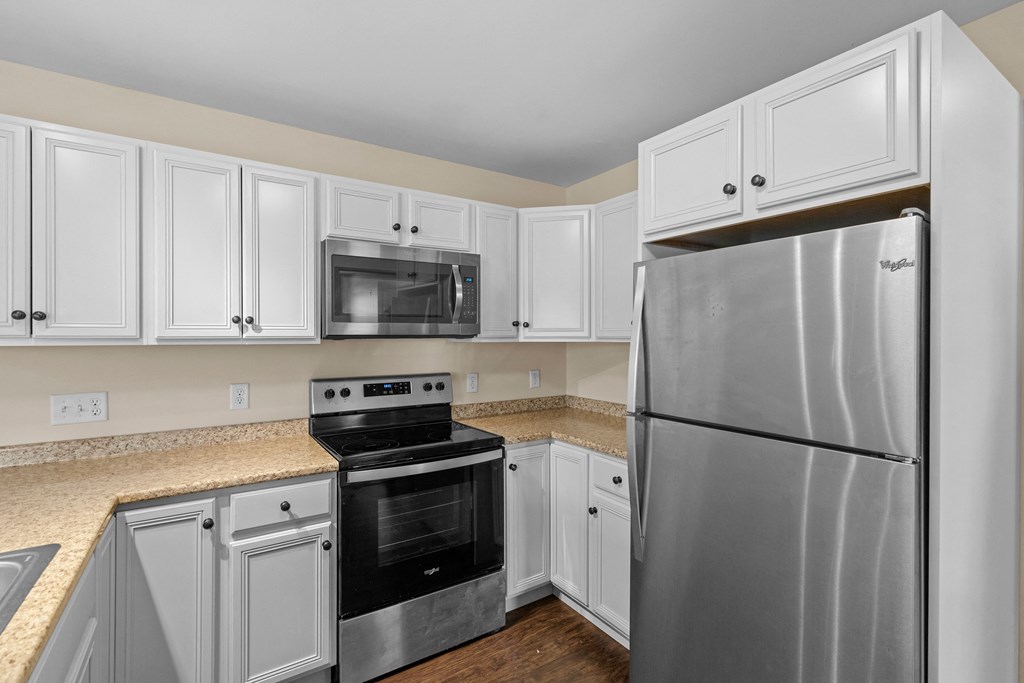 a kitchen with stainless steel appliances and white cabinets