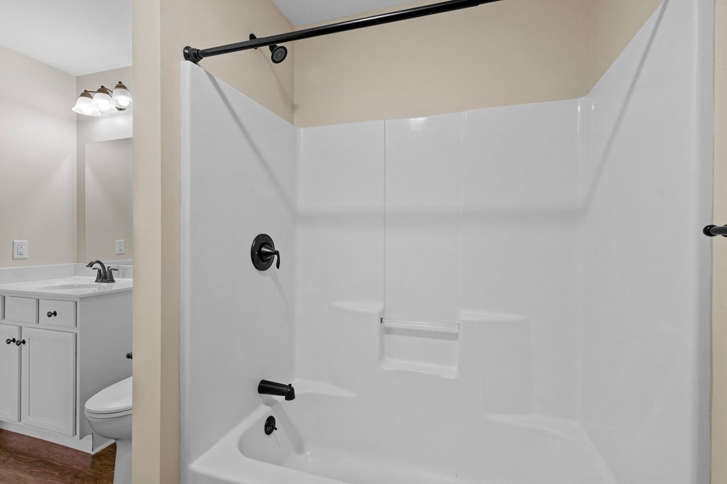 a bathroom with a shower and a sink and a toilet