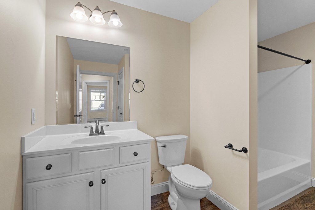 a bathroom with a sink toilet and a mirror