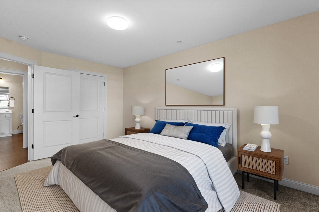 a bedroom with a bed and a mirror on the wall