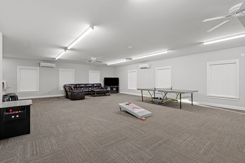 a living room with a couch coffee table and a television