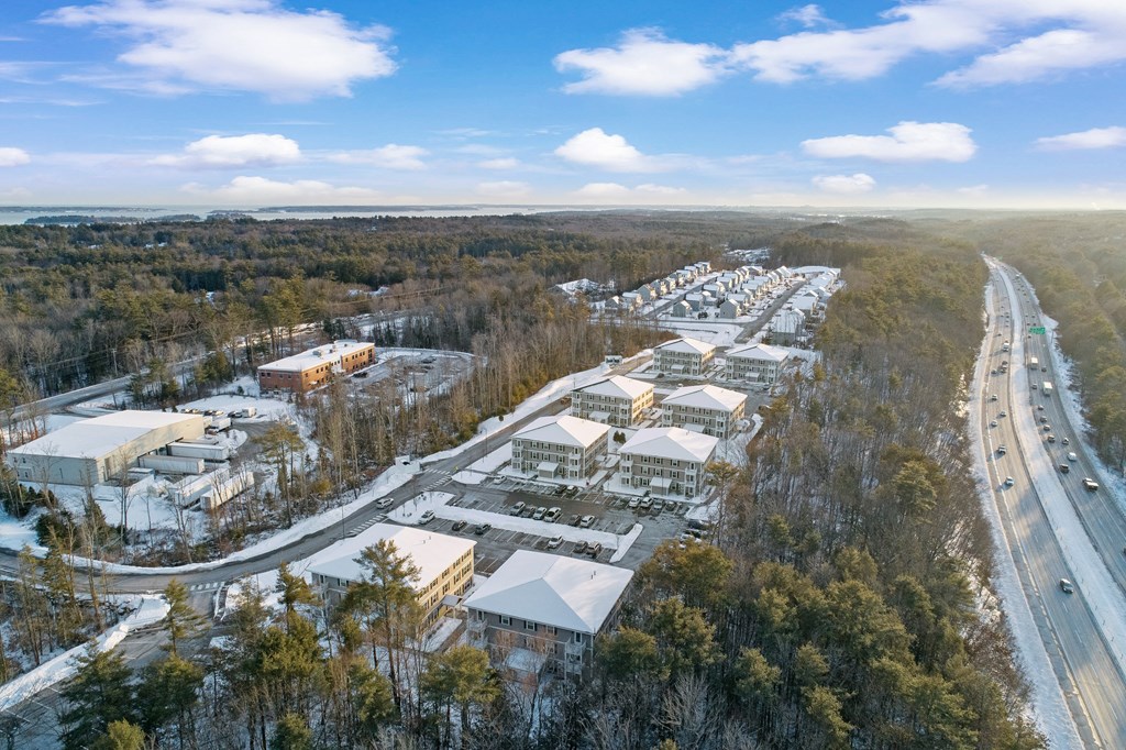 an aerial view of a snow covered city with a highway