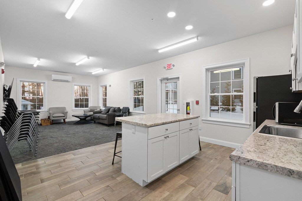 an open living room and kitchen with a counter top in the middle
