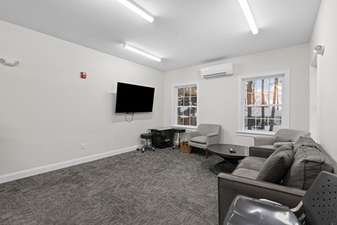 the living room of an apartment with a couch and a tv