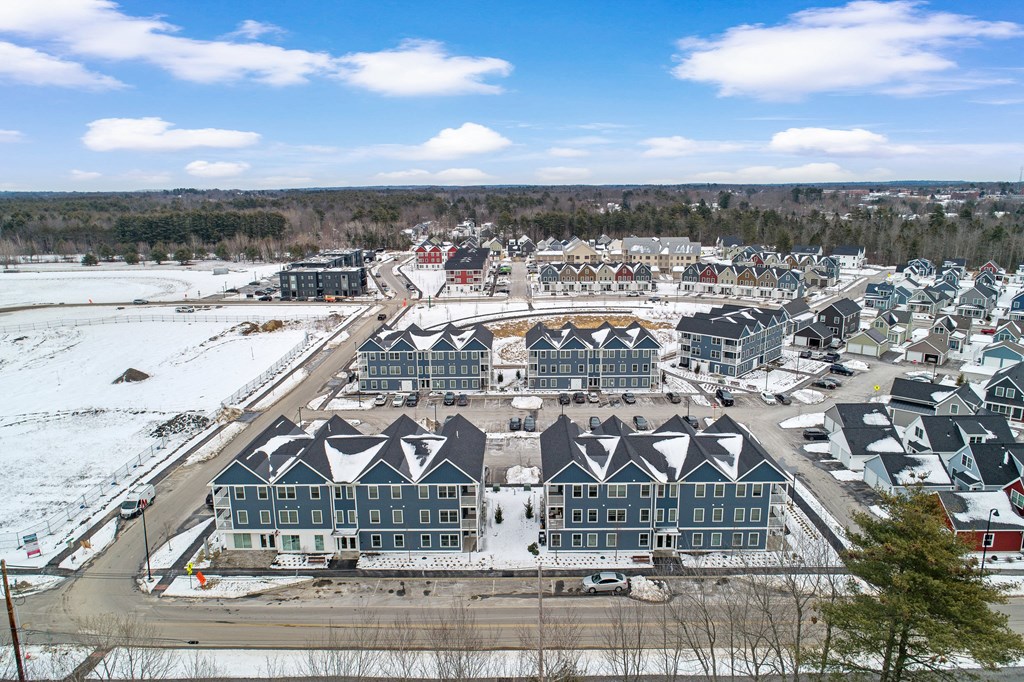 an aerial view of a housing development in a city in the snow
