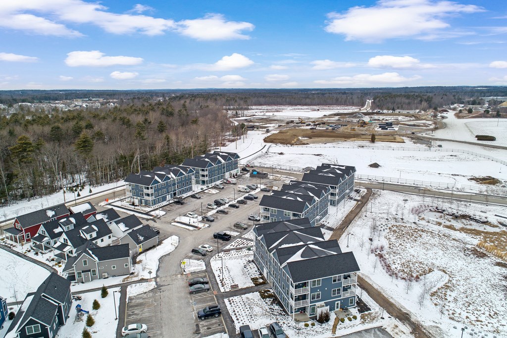 an aerial view of a group of houses in the snow