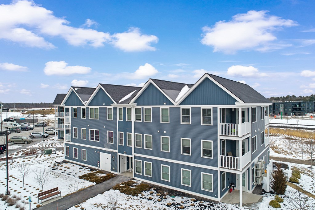 an aerial view of an apartment building in the snow