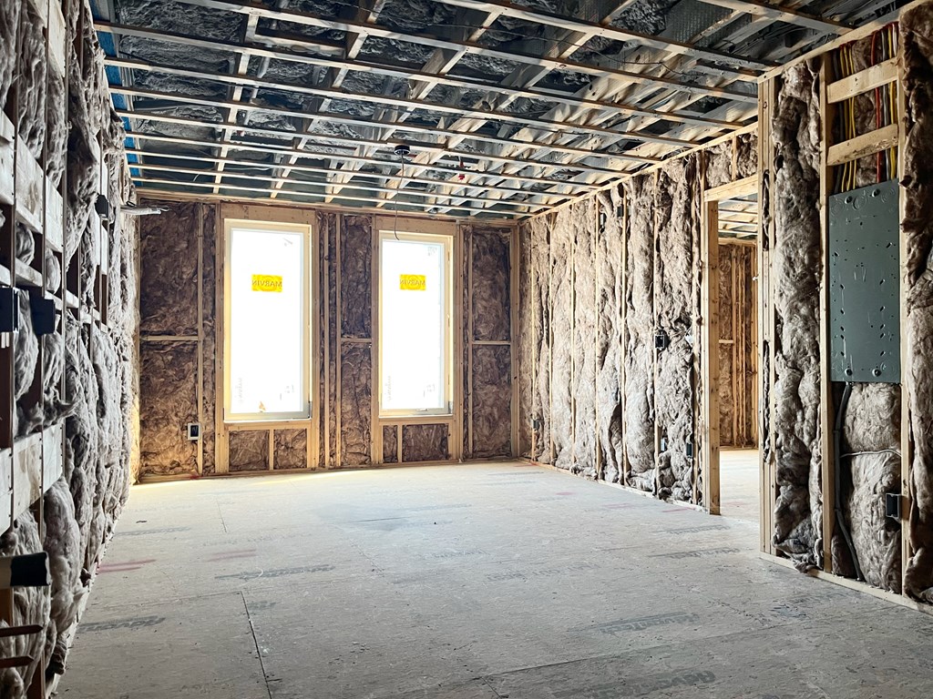 a room that is being remodeled with wood walls and a ceiling covered in insulation