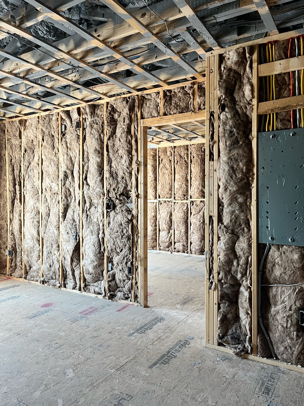 a room being remodeled with a wall of insulation and a door