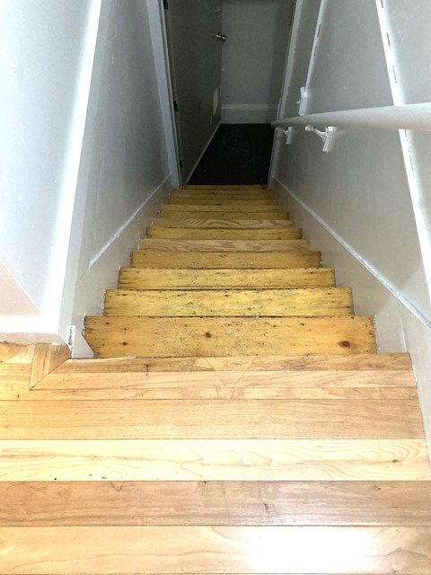 the stairs are made of wood and are going up and down