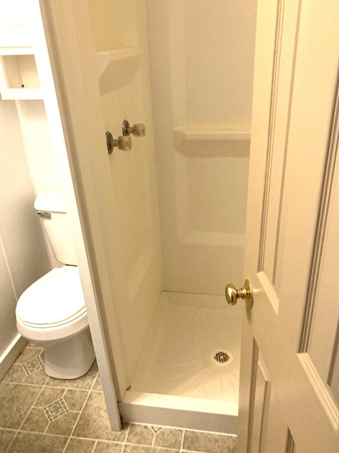 a small bathroom with a shower and a toilet