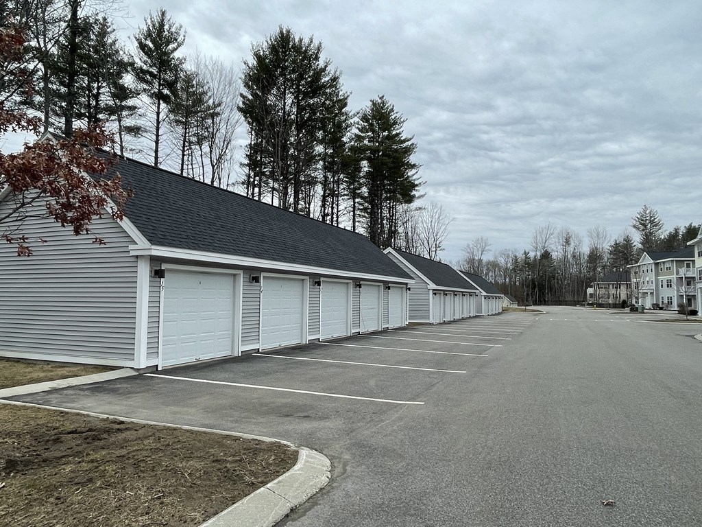 a row of garages on the side of a road