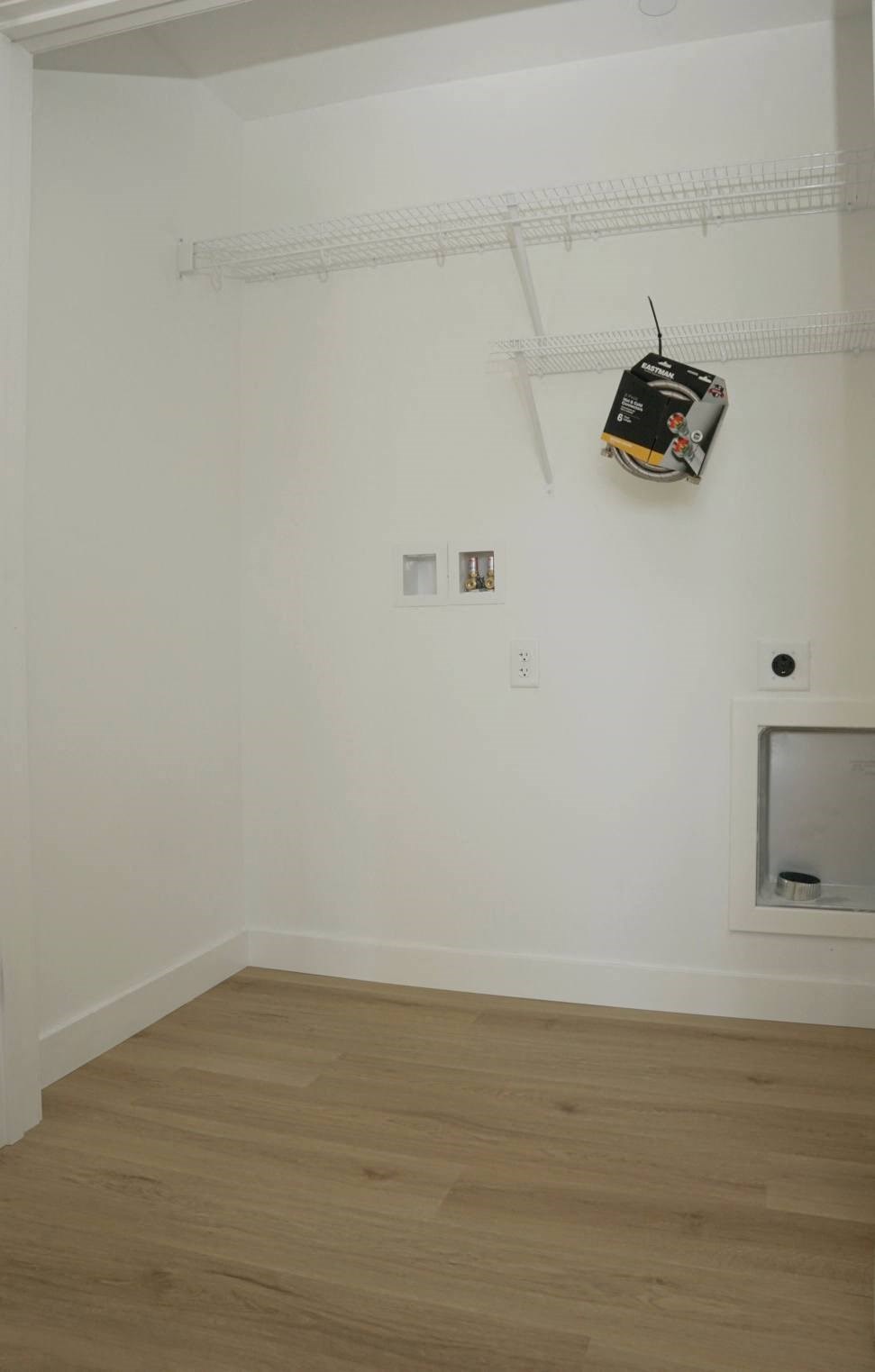 a wall with a television and a bag hanging on the wall