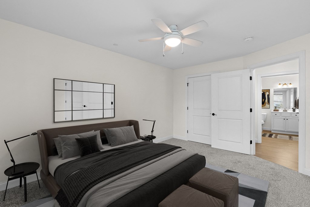 a bedroom with a large bed and a ceiling fan