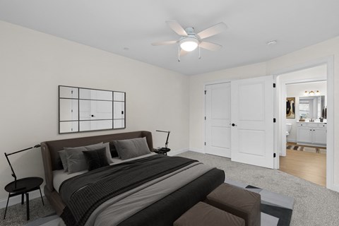 a bedroom with a large bed and a ceiling fan