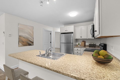 a kitchen with a granite counter top and a sink