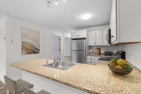 a kitchen with a granite counter top and a sink