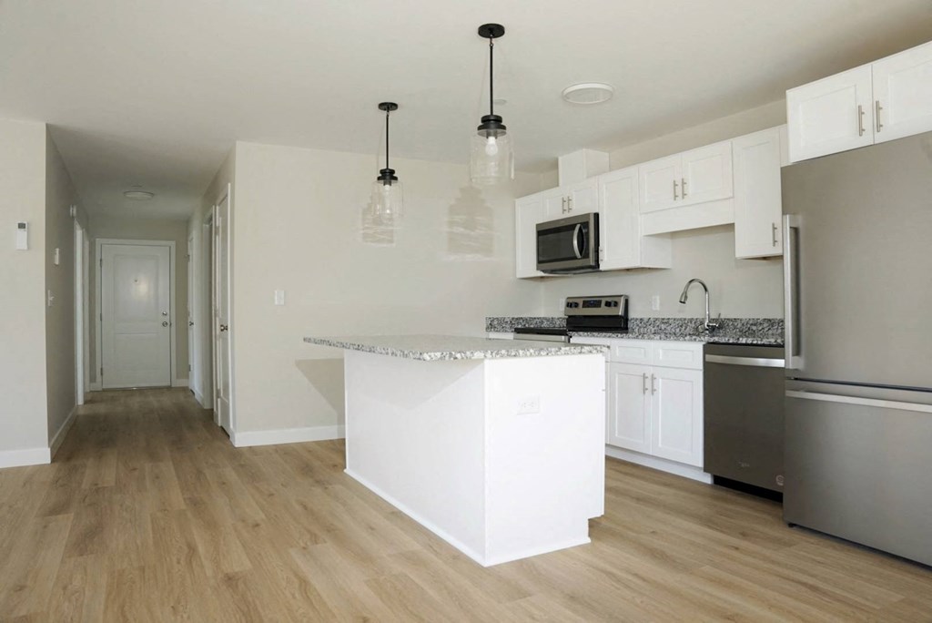 a kitchen with an island and stainless steel appliances
