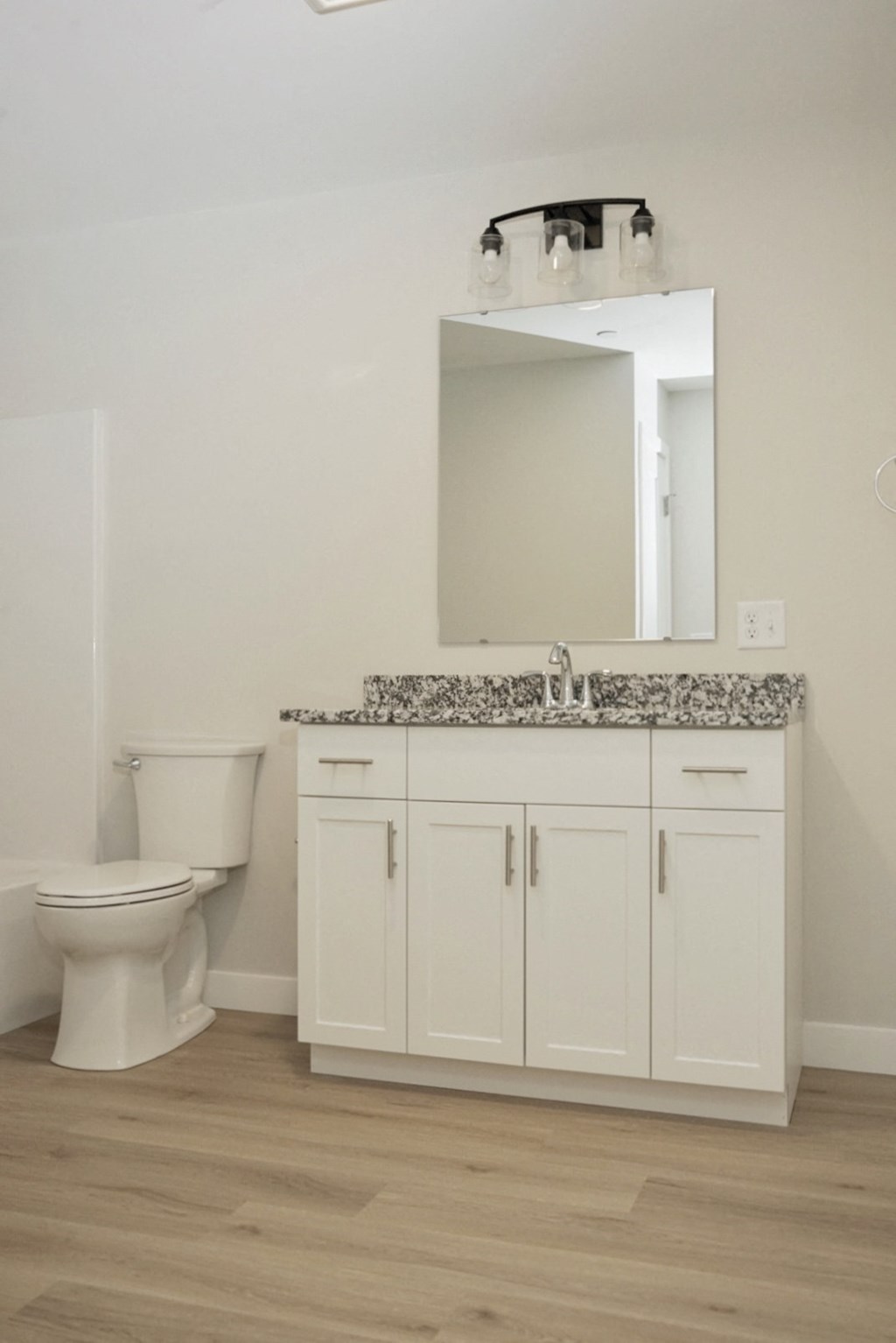 a bathroom with a toilet and a sink and a mirror
