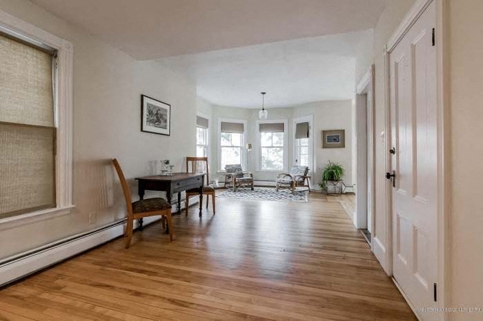 a living room and dining room with a wood floor