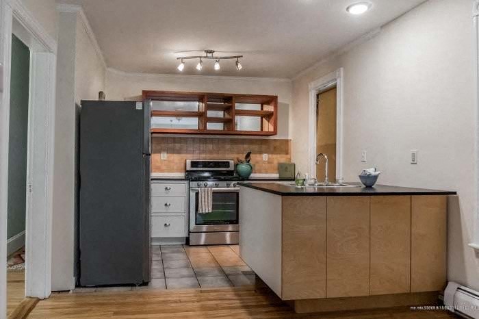 a kitchen with a refrigerator and a sink