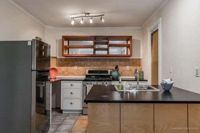 a kitchen with a stove and a sink and a refrigerator