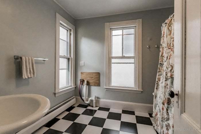 a bathroom with a black and white checkered floor