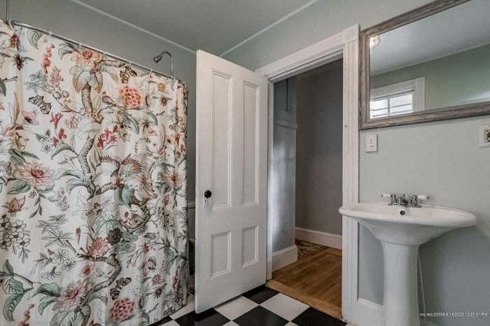 a bathroom with a shower curtain and a sink