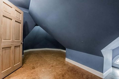 a blue room with a blue wall and a wooden door