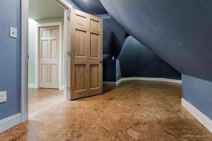 a empty room with a door and a blue wall