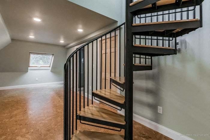 a spiral staircase in a house with a wood floor