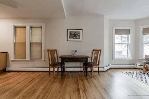 a dining room with a table and two chairs