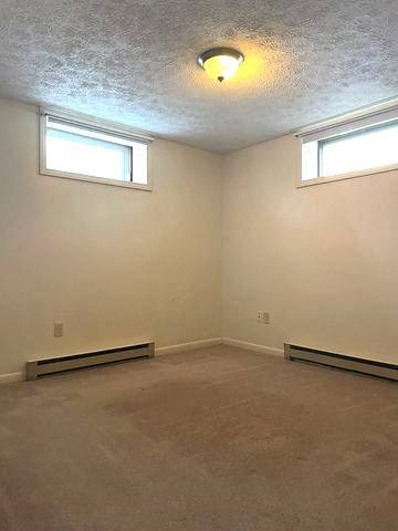 an empty room with two windows and a light on the ceiling