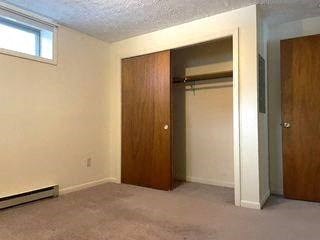 an empty living room with a door to a closet