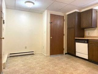 an empty kitchen with a stove and a refrigerator