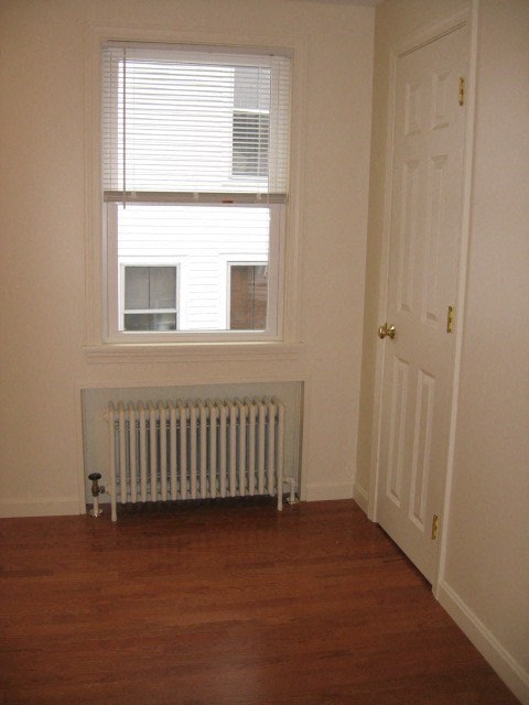 a room with a radiator and a window