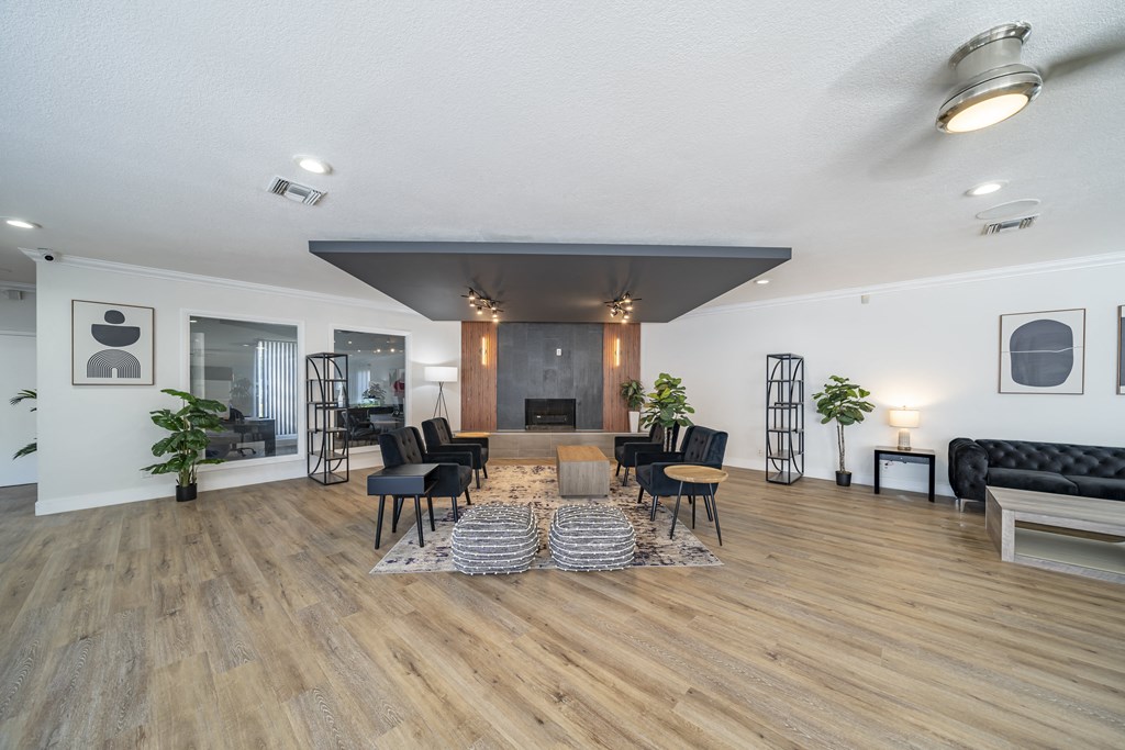 A modern living room with a fireplace and a black couch. at Red Bay Apartment Complex, Jacksonville, FL, 32211