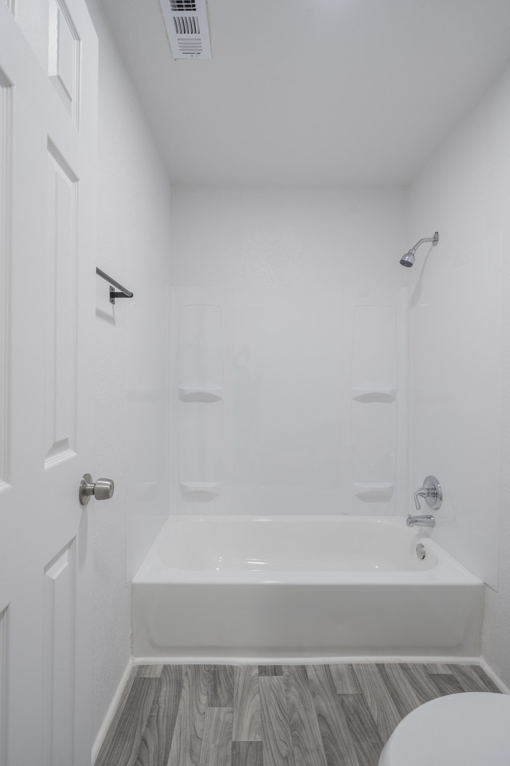 A white bathroom with a bathtub, toilet, and sink at Red Bay Apartment Complex, Jacksonville, FL, 32211