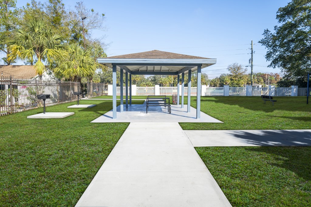 A pavilion with a white walkway in front of it. at Red Bay Apartment Complex, Jacksonville, FL, 32211