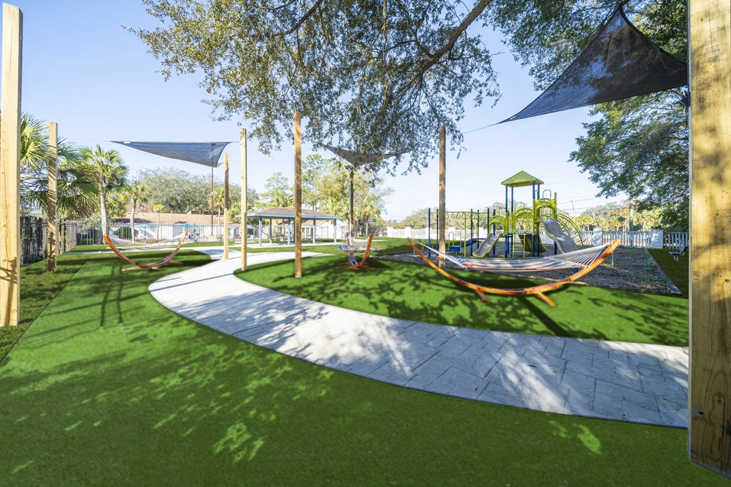A playground with a slide and a swing set. at Red Bay Apartment Complex, Jacksonville, FL, 32211