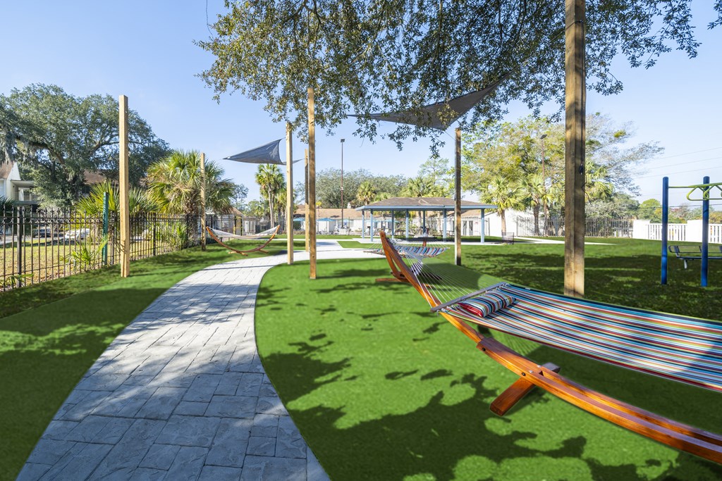 A park with a hammock between two trees. at Red Bay Apartment Complex, Jacksonville, FL, 32211
