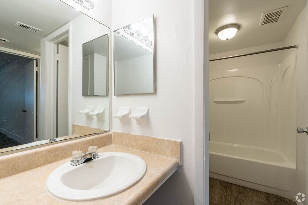 a bathroom with a sink and a mirror at Red Bay Apartment Complex, Florida, 32211